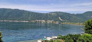 a view of a river with mountains in the background at Terra intelvi in San Fedele Intelvi