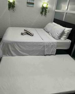 two beds with tongs sitting on top of them at Mi Casa in Tagaytay