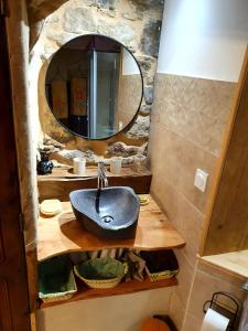 a bathroom with a sink and a mirror at Studio l'envoûté in Saint-Rome-de-Tarn