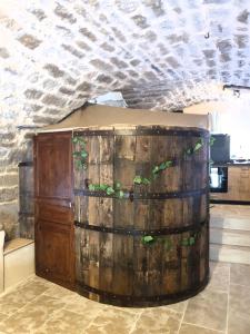 a large wooden barrel with plants on top of it at Studio l'envoûté in Saint-Rome-de-Tarn +2 photos