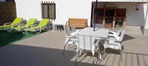 a white table and chairs on a patio at Murta's Home in Cadaval