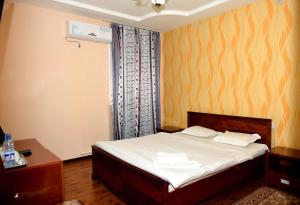 Postel nebo postele na pokoji v ubytování Carat Hotel