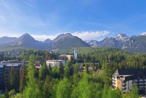 a view of a city with mountains in the background at Apartmány hotela CROCUS Štrbské Pleso in Štrbské Pleso