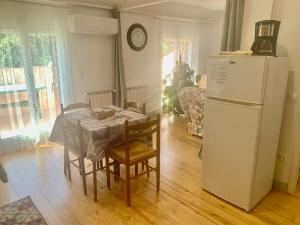 a kitchen with a table and a white refrigerator at Chez Pierre in Le Val