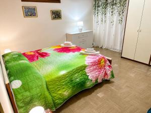 a bedroom with a large bed with flowers on it at Vista Isole Eolie in Piraino