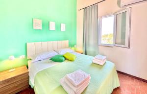a bedroom with a bed with towels on it at La Nuova Rinascita in San Giovanni Suergiu
