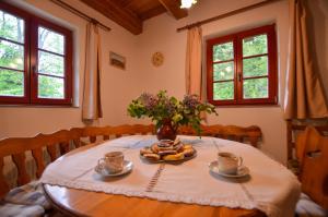 a dining room table with a vase of flowers on it at Jezinka Dolní Morava in Dolní Morava