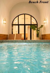 a swimming pool in a hotel with the words beach front at Théo Privé Kohlarn in Ko Lan
