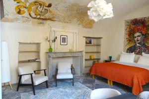 a bedroom with a bed and a fireplace at Ancienne eglise in Vallérargues
