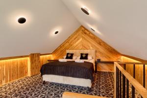 a bedroom with a bed in a attic at Rezydencja Skibówki Apartamenty Domki Jacuzzi in Zakopane