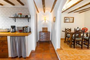 a kitchen with a counter and a dining room at Casa Rural Mas Halcón in Useras