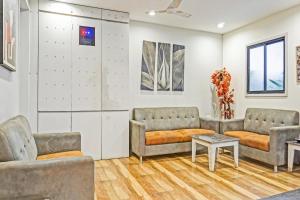 a waiting room with two couches and a table at Collection O Royce Studios Near Pune Airport in Pune