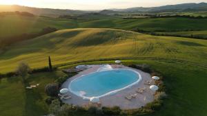 an overhead view of a swimming pool in a field at RELAIS VAL D'ORCIA in Pienza