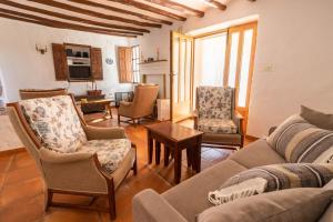 a living room with a couch and chairs and a table at Casa Rural Mas Halcón in Useras
