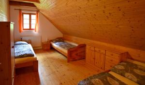 a attic room with two beds and a window at Jezinka Dolní Morava in Dolní Morava