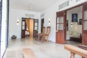 a living room with chairs and a couch at Rodrigo House in Colombo