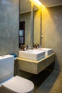 a bathroom with a sink and a toilet and a mirror at Rodrigo House in Colombo +32 photos