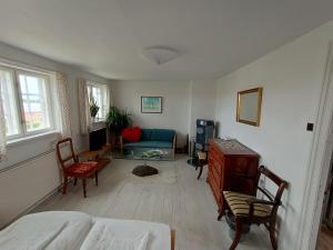 a living room with a bed and a couch at Aakirkeby Bed and Breakfast in Åkirkeby