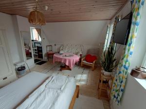 a bedroom with a bed and a table in a room at Aakirkeby Bed and Breakfast in Åkirkeby