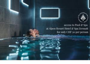 an image of a woman in a swimming pool at Matterhorn Inn - Wellness & Dining - at Zermatt Shuttle Station in Täsch