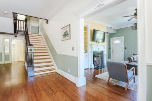 a living room with a staircase and a chair at Clonmel Acres in Afton