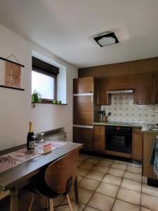 a kitchen with a table with a bottle of wine at Ferienwohnung Tutbach in Jünkerath