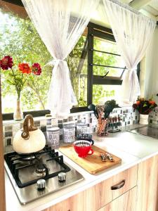a kitchen counter with a stove and a window at The Little Cove in Vaal Marina