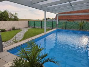 a swimming pool in a backyard with a pergola at Tiny Haus in Bad Sulza