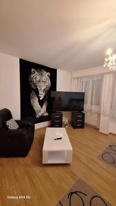 a living room with a picture of a tiger on the wall at Spalentor City Apartement in Basel