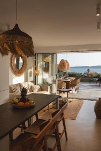 a living room with a table with a bowl of fruit at Villa Ammos with Private Pool, Sauna & Seaview in Gialova