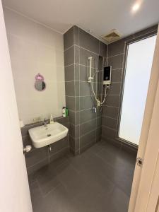 a bathroom with a sink and a shower at aloha homestay in Miri