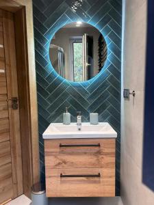 a bathroom with a sink and a mirror at DOMKI , Pokoje gościnne Ustronie in Zwierzyniec +63 photos