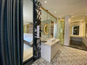 a bathroom with a shower and a bed in a room at VMona Hotel in Thôn Kim Long (1) +56 photos