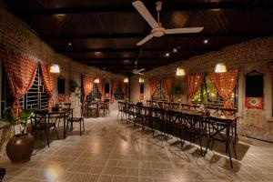 a dining room with tables and chairs and a ceiling at Tada Moc Chau - Villa & Local Kitchen in Mộc Châu