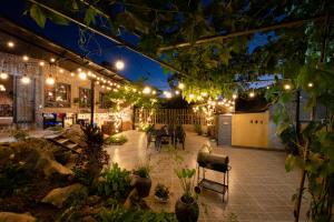 a patio lit up at night with lights at Tada Moc Chau - Villa & Local Kitchen in Mộc Châu