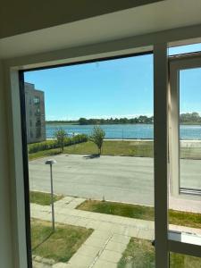 a window with a view of a parking lot at South Harbour Studios in Vordingborg +2 photos