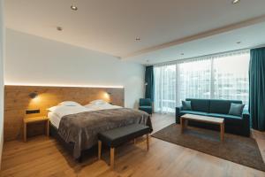 a hotel room with a bed and a couch at Zermatt Budget Rooms at Alpen Resort, Spa & Dining in Zermatt +30 photos