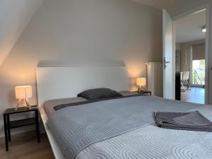 a bedroom with a large bed and two lamps at Pool & Chill Balaton in Balatonvilágos +49 photos