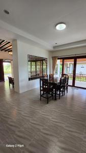 a dining room with a table and chairs at Chaya village B - a shared pool & Jacuzi in Ko Lanta