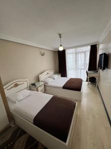 Postelja oz. postelje v sobi nastanitve Şeref Hotel