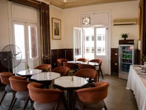 a restaurant with tables and chairs and a clock on the wall at City View Museum Hotel in Cairo