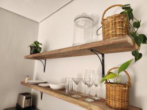 a shelf with wine glasses and baskets on it at Windsor Cottage in Avondale +10 photos