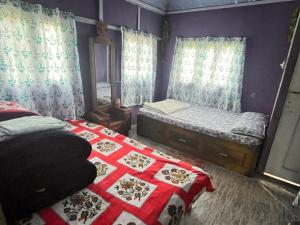 a small bedroom with two beds and a mirror at Live in Nature in Darjeeling +43 photos