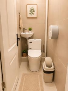 a small bathroom with a toilet and a sink at LG53 Tour & Hostel in Ulaanbaatar +13 photos