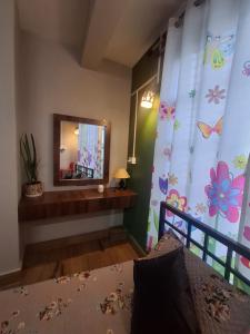 a bedroom with a bed and a mirror in a room at GD Homestay in Shillong +3 photos