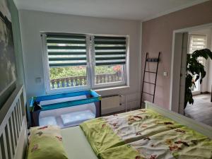 a bedroom with a bed and a window with shutters at Ferienwohnung Am See 55 in Bad Saarow