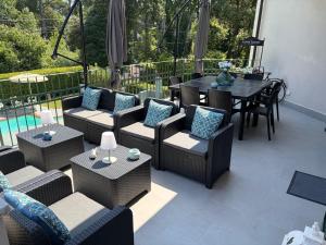 a patio with couches and tables and a table and chairs at Lightblue in Marina di Massa