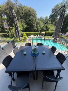 a blue table and chairs on a patio with a pool at Lightblue in Marina di Massa