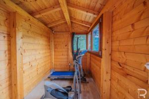 an inside view of a log cabin with a treadmill at Tuscan house, exclusive pool, private garden in Bagni di Lucca