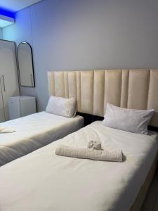 two beds sitting next to each other in a room at Deluxe Nest - Windhoek in Windhoek